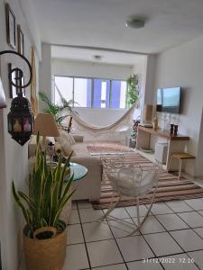 a living room with a couch and a chair at apartamento na praia de Iracema com vista mar in Fortaleza