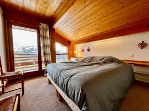 a bedroom with a bed and a wooden ceiling at Chalet Crest-Voland, 7 pièces, 8 personnes - FR-1-505-181 in Crest-Voland