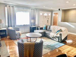 a living room with a couch and chairs and a table at Cedar Mill Hideaway in Woodbury