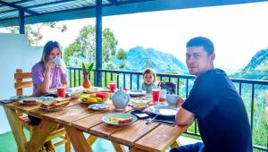 a man and a woman sitting at a table eating food at Onestar Ella in Ella