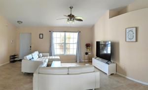 a living room with a couch and a tv at Villa Luhna 3 Bed / 2 Bath Canalfront Heated Pool in Cape Coral