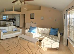a living room with a couch and a table at Villa Luhna 3 Bed / 2 Bath Canalfront Heated Pool in Cape Coral