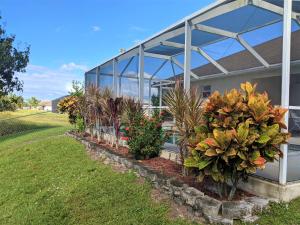 a row of plants in front of a building at Villa Luhna 3 Bed / 2 Bath Canalfront Heated Pool in Cape Coral