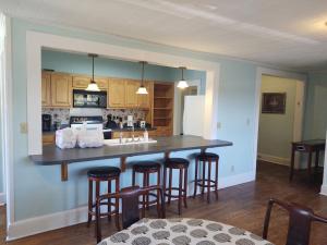 a kitchen with a large island with bar stools at Welcome To Downtown Pickens close to Clemson and Lake Keowee in Pickens