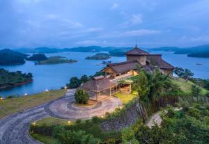 a house on a hill with a view of a lake at MOUNTAIN SHADOWS RESORTS in Wayanad