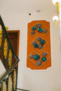 a wall with a bunch of cupcakes on a wall at De'Colore Villa Hoi An in Hoi An