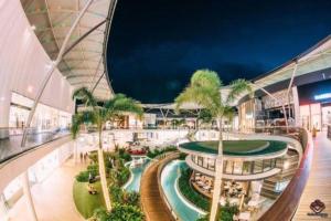 an indoor mall with palm trees and a building at Casino residence 2-BR ocean view in Gold Coast