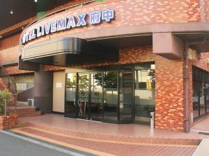 a building with a sign on the front of it at HOTEL LiVEMAX BUDGET Fuchu in Fuchu