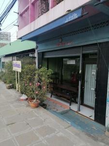 uma frente de loja com plantas em frente a um edifício em Auntie House985 em Phra Nakhon Si Ayutthaya