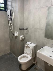 a bathroom with a toilet and a sink at A Home - Homestay near St Anne Church Bukit Mertajam in Bukit Mertajam