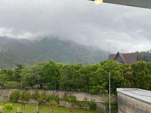 a view of a mountain with a wall and trees at A Home - Homestay near St Anne Church Bukit Mertajam in Bukit Mertajam