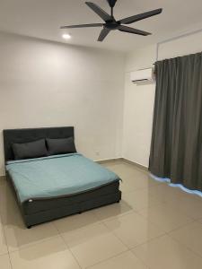 a bedroom with a bed and a ceiling fan at A Home - Homestay near St Anne Church Bukit Mertajam in Bukit Mertajam