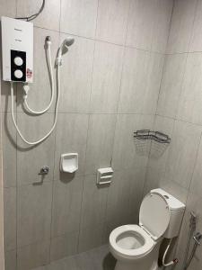 a shower stall with a toilet in a bathroom at A Home - Homestay near St Anne Church Bukit Mertajam in Bukit Mertajam +6 photos