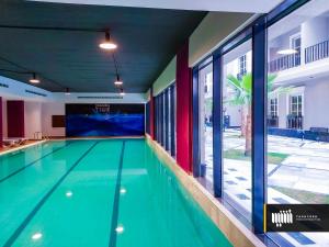 a swimming pool in a building with a large window at luxury 3BR Condo Near the Boulevard in Riyadh
