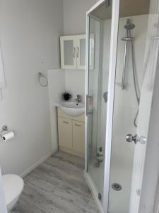 a bathroom with a shower and a sink at K&R Orewa homestay in Orewa