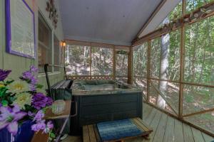 uma casa de banho com um lavatório num quarto com janelas em Misty Mountain Hop - Cobbly Nob Cabin with HotTub, Fast Wi-Fi, Privacy, Pool em Gatlinburg