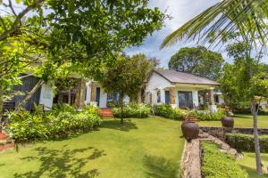 a house with a yard in front of it at Santa Garden Resort in Phu Quoc
