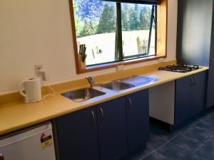 a kitchen counter with two sinks and a window at Off the Beaten Track B&B in Canvastown