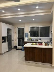 a large kitchen with a large island in the middle at Elysium Service Apartment 1203 in Islamabad