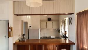 a kitchen with a counter and a refrigerator at Stella Maris 53 in Amanzimtoti