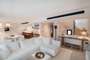 a living room with a white couch and a table at OVILIO KALAMATA in Kalamata