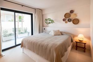 a bedroom with a bed and a large window at OVILIO KALAMATA in Kalamata