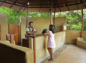 a little girl standing at a counter with a man at Leopard Nest - Glamping in Yala in Yala