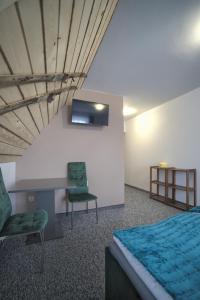 a bedroom with a bed and a desk and a chair at Wiyrchowianka in Gliczarów Górny