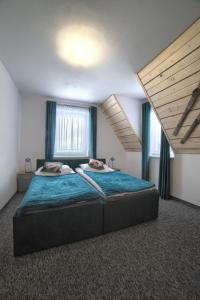 a bedroom with a large bed with blue sheets at Wiyrchowianka in Gliczarów Górny +60 photos
