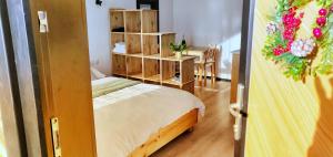 a small bedroom with a bed and a table at Birtok Houses- twin no 1 for 2 people in Borzont