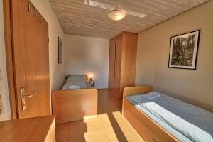 a small room with two beds and a desk at Ersfeld - Bad Teinach Zavelstein in Bad Teinach-Zavelstein