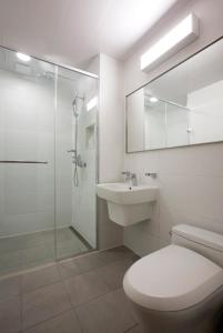 a bathroom with a toilet and a sink and a shower at Hanwha Resort Daecheon Paros in Boryeong