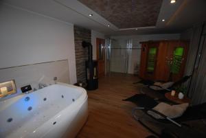 a large bathroom with a tub in a room at Ferienwohnung Christina in Mauth