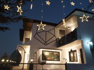 a house with christmas lights hanging from it at THE FOX RETREAT in Mukteshwar