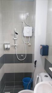 a bathroom with a shower with a toilet and a sink at Stobericekelathomestaymuslim's in Cameron Highlands