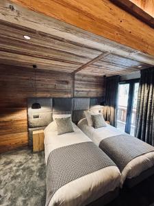 Ένα ή περισσότερα κρεβάτια σε δωμάτιο στο Hameau des Prodains - Résidence