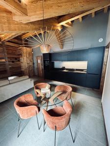 a room with chairs and a table and a couch at Hameau des Prodains - Résidence in Morzine