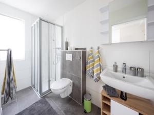 a white bathroom with a toilet and a sink at Zur Altstadt in Monschau +33 photos