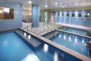 a large swimming pool with two lanes in a building at Hanwha Resort Jeju in Jeju