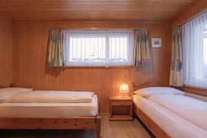 Postel nebo postele na pokoji v ubytování Apartment Jungfrau Lodge