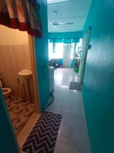 a hallway of a room with a blue wall at Hazaff Homestay in Sungai Petani