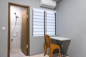 a bathroom with a sink and a desk and a shower at Graha Asri Syariah in Waru