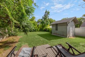 a backyard with a shed and a table at Near Bishop Arts District Spacious 3 Bedroom Home! in Dallas