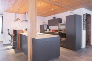 a kitchen with a stove and a counter top at Apartment Renata in Grindelwald