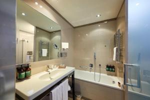 a bathroom with a sink and a shower and a tub at Crowne Plaza Verona Fiera, an IHG Hotel in Verona