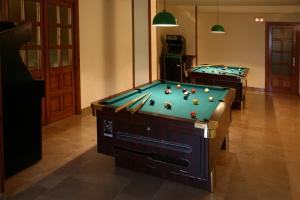 two pool tables with balls on them in a room at Hotel Villa de Canfranc in Canfranc-Estación