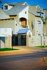 a building with a sign in front of it at Regent Kgale Lodge in Gaborone
