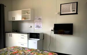 um quarto com uma cama e uma televisão e uma cama gmaxwell gmaxwell gmaxwell em Lakes Bushland Caravan & Lifestyle Park em Nicholson