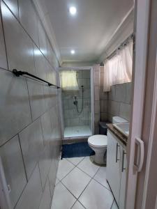 a bathroom with a shower and a toilet and a sink at Villa Pesca Self Catering accommodation in Richards Bay