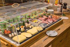 a buffet with cheese and meats and other foods at Arndt Hotel Garni in Rust